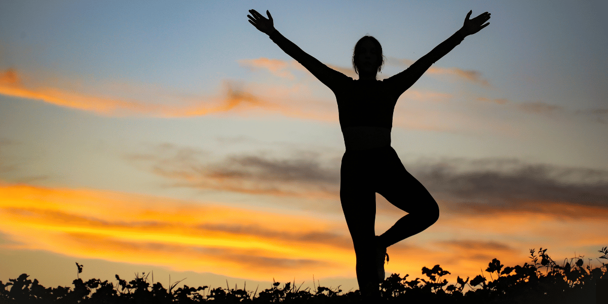 person striving for continuous growth and success through challenge with sunset in background