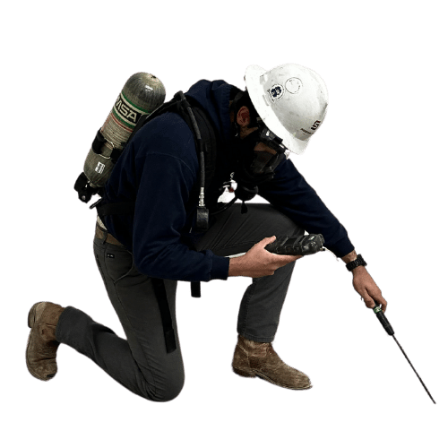 Worker in a hard hat and respiratory mask on the job