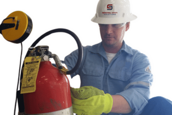 A worker performing an extinguisher inspection